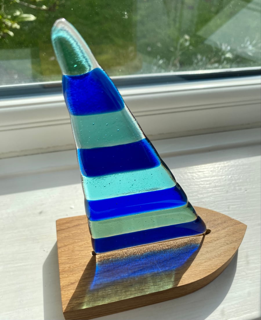 Fused glass sail in a solid oak stand 