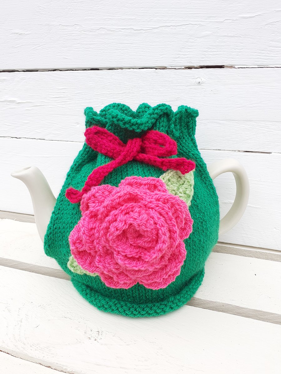 Handknitted Tea Cosy in Green with Large Pink Crochet Flower
