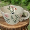 handthrown mug with flower detail