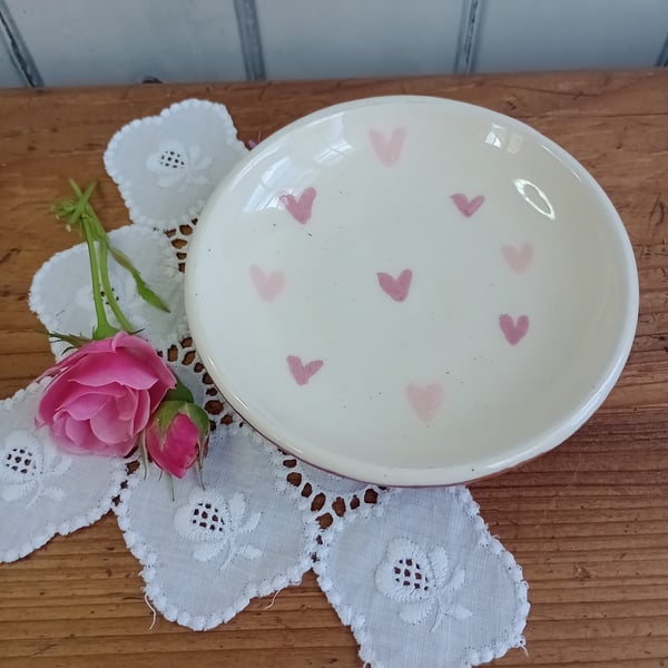 White jewellery dish with pink heart design