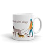 Ceramic mug featuring an illustration of a female walking a pack of cute dogs. 