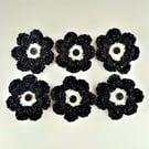 Crochet flowers in monochrome glitter yarn with black button in the middle