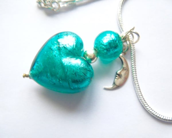  Murano glass green heart pendant with sterling silver charm and chain.