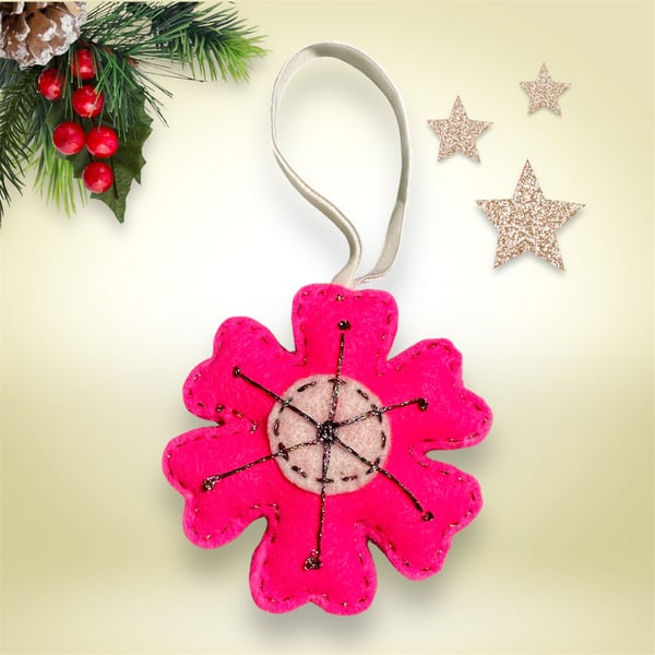 A bright pink & white snowflake tree decoration, multicoloured metallic thread  