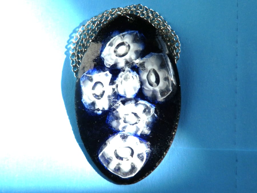 enamelled pendant - white millefiore on a dark blue oval