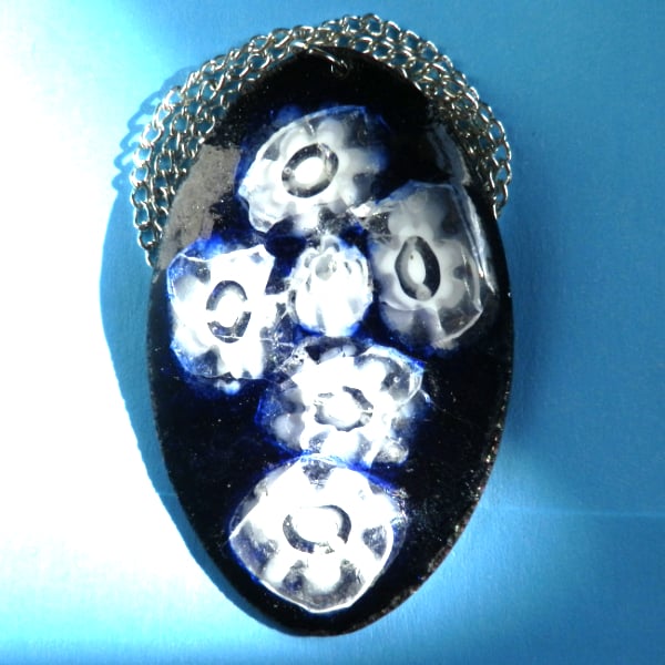 enamelled pendant - white millefiore on a dark blue oval