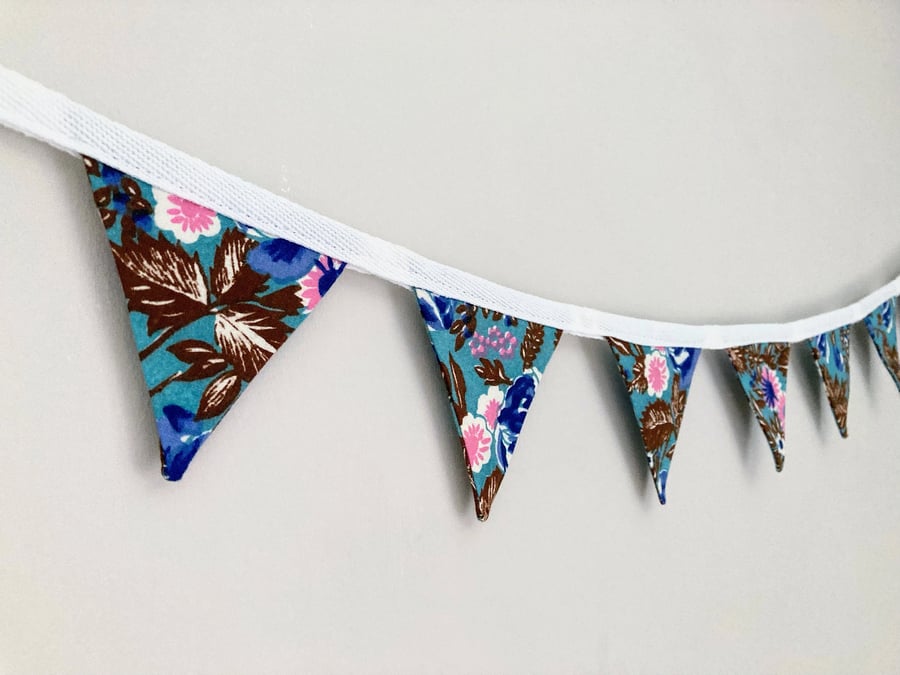 Flowers on blue double sided cotton fabric mini bunting. 