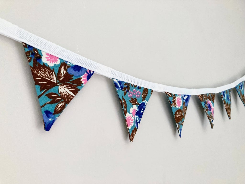 Flowers on blue double sided cotton fabric mini bunting. 