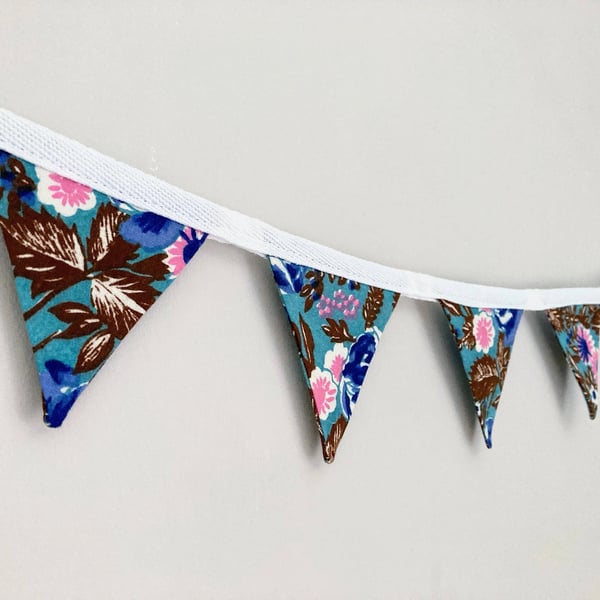 Flowers on blue double sided cotton fabric mini bunting. 