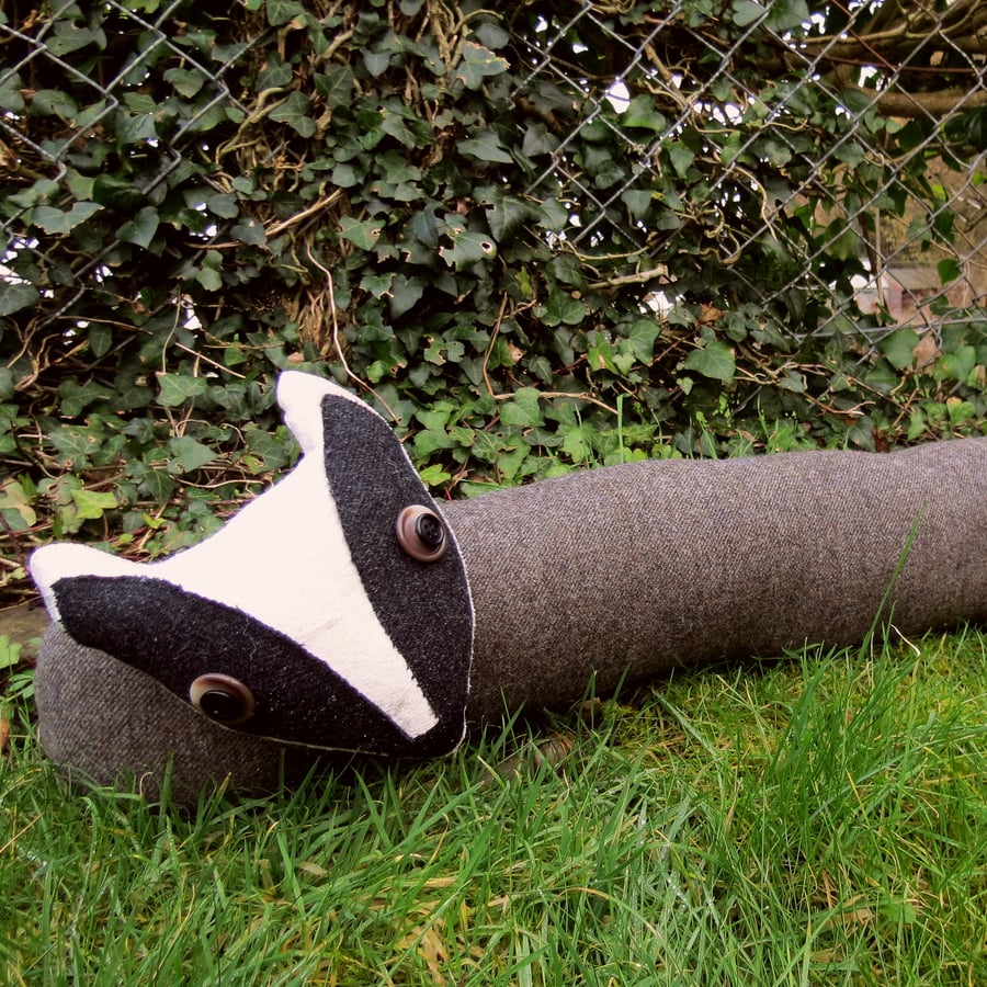 The curious badger.  A draught excluder made from wool.  110cm in length.