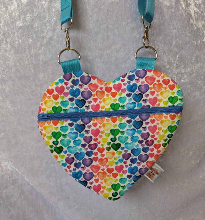 Heart shaped cross body bag with blue strap.