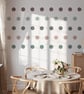 Eco-friendly nursery wall stickers featuring printed polka dots in neutral tones