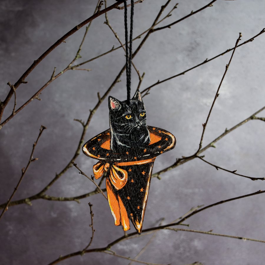 Black cat in a Halloween witch hat hanging decoration 