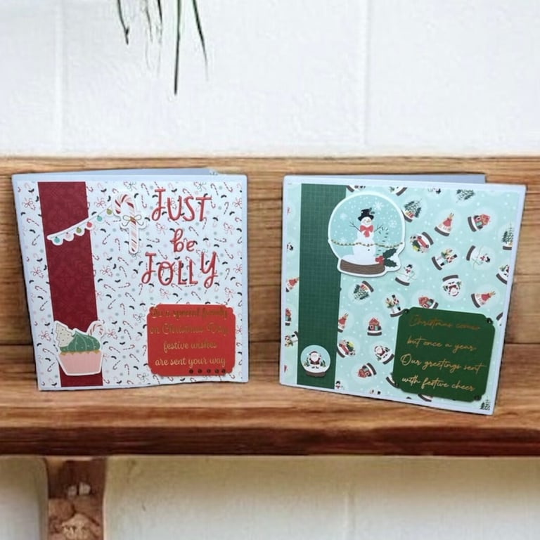Set of two Christmas cards featuring Santa, snowmen snow globes and candy canes.