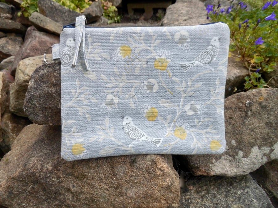 Make up bag in grey and yellow bird print fabric with zip