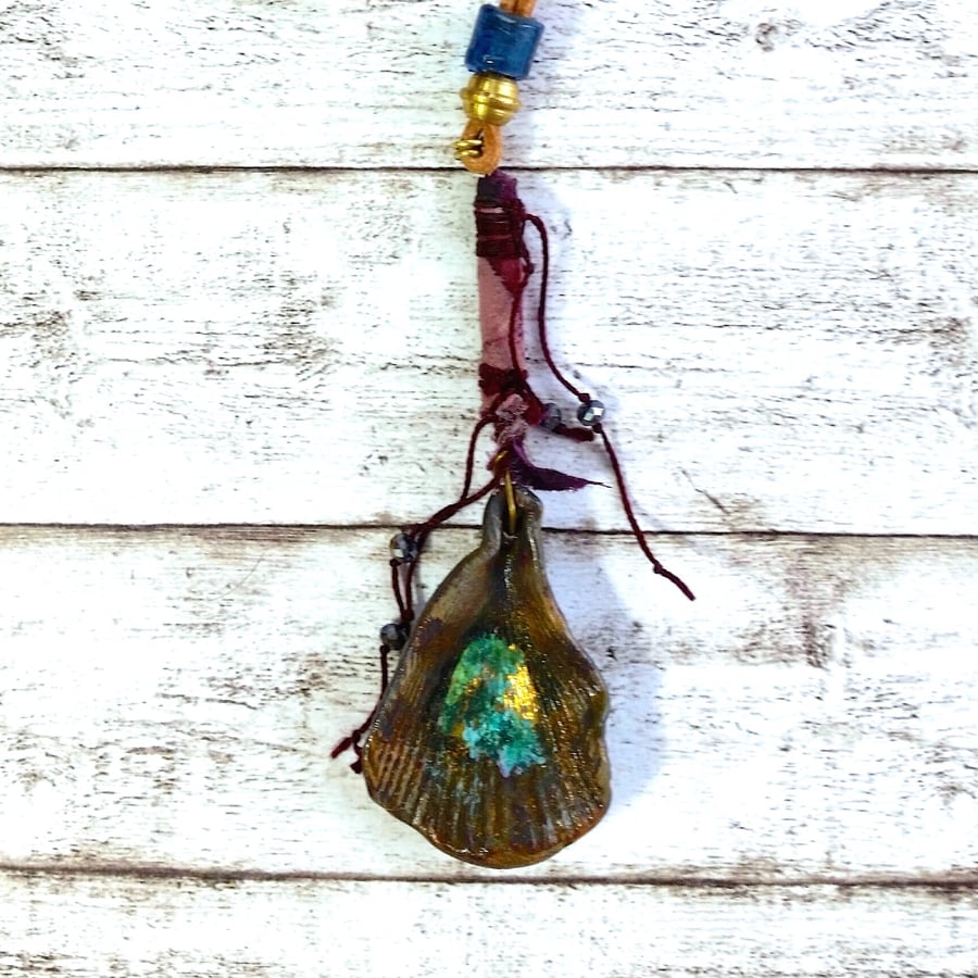 Silk wrapped bead and polymer shell pendant.