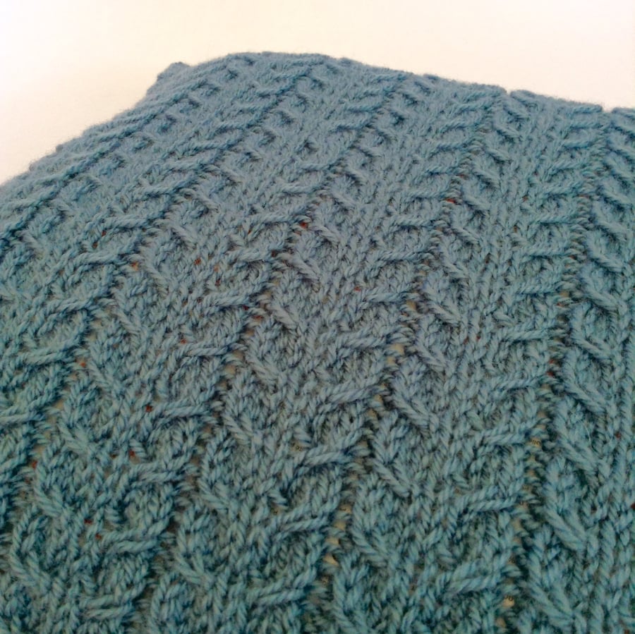 Hand-knitted blue cable cushion cover