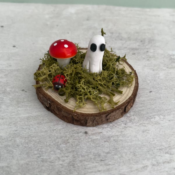 Adopt a Pet ghost on a log slice  