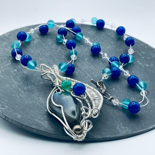 Beautiful blue agate pendant on beaded chain.