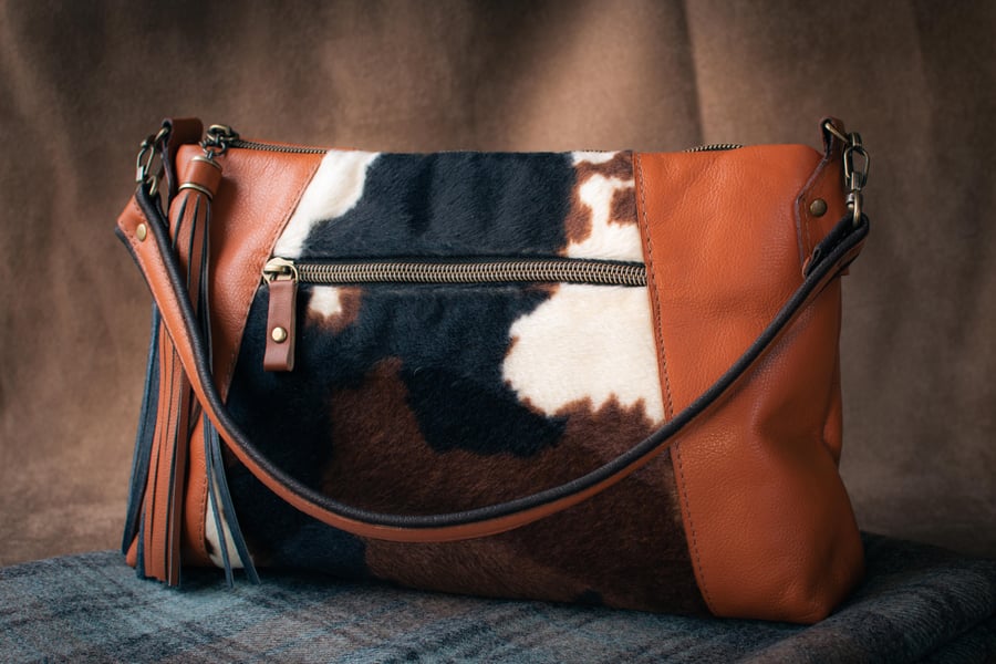 Soft tan leather bag with faux cow hide fabric panel on the front
