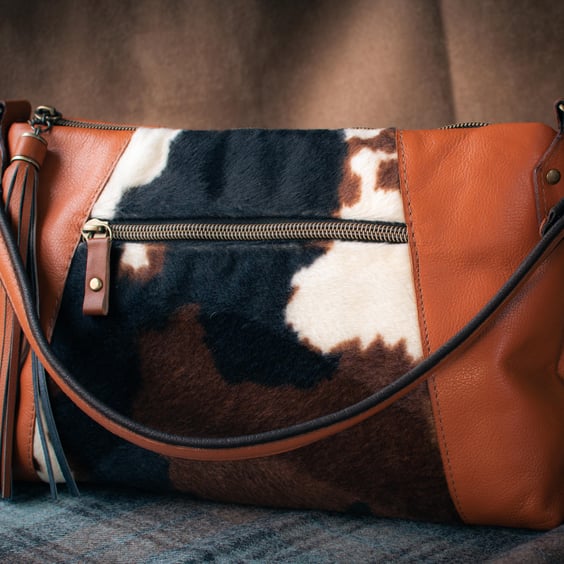 Soft tan leather bag with faux cow hide fabric panel on the front