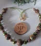 Polymer clay necklace in a brown swirl design with a hint of sparkle - Image 3