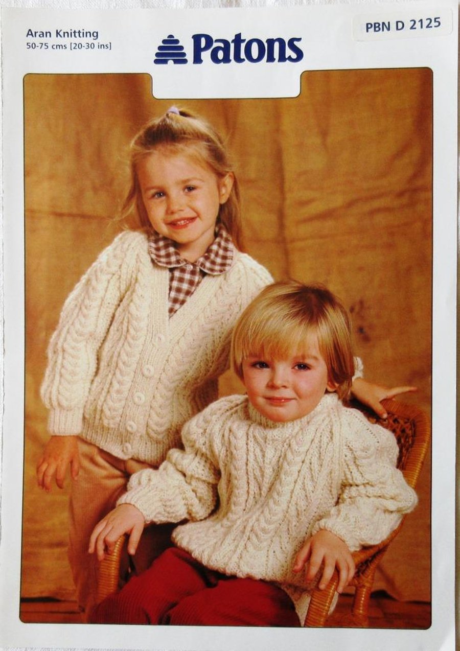 A knitting pattern for a child's cardigan and sweater in Aran yarn (Patons)