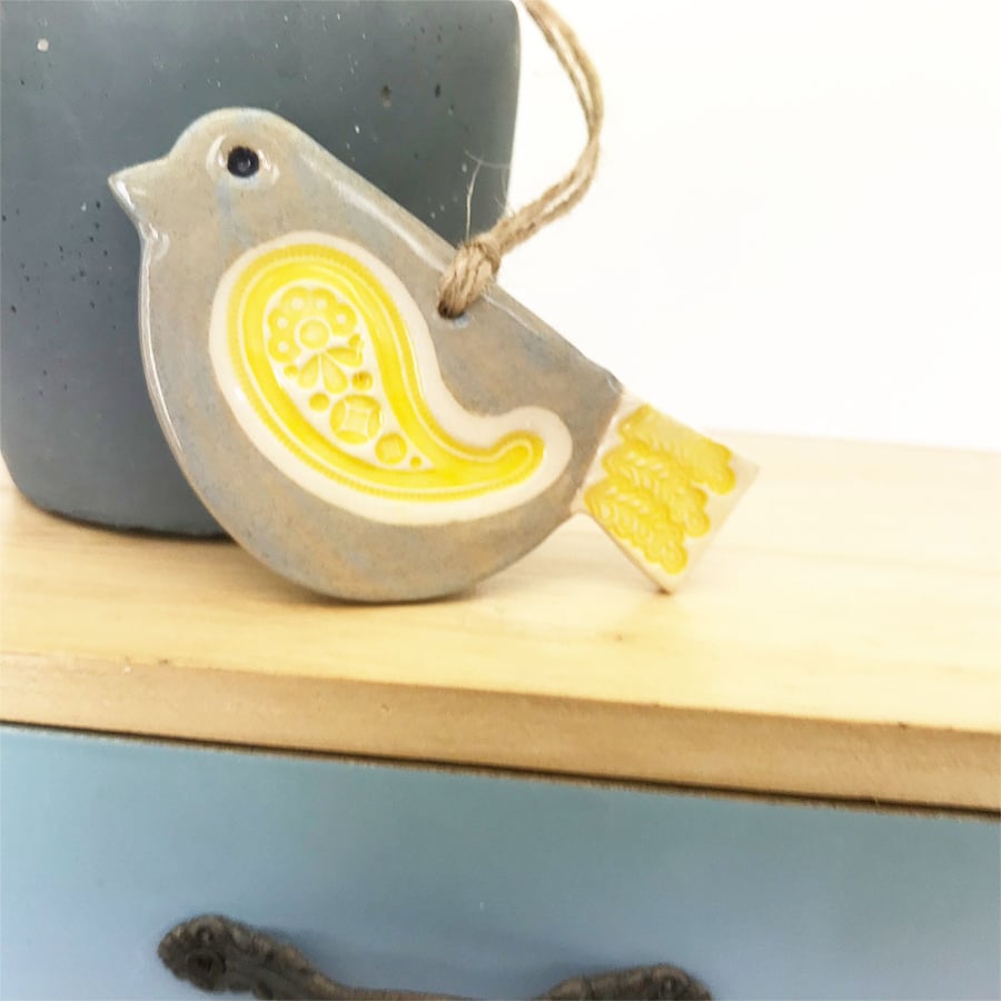 Ceramic bird decoration with patterned wing and tail 