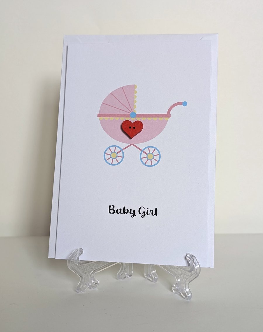 Baby girl pram with red heart button greetings card 