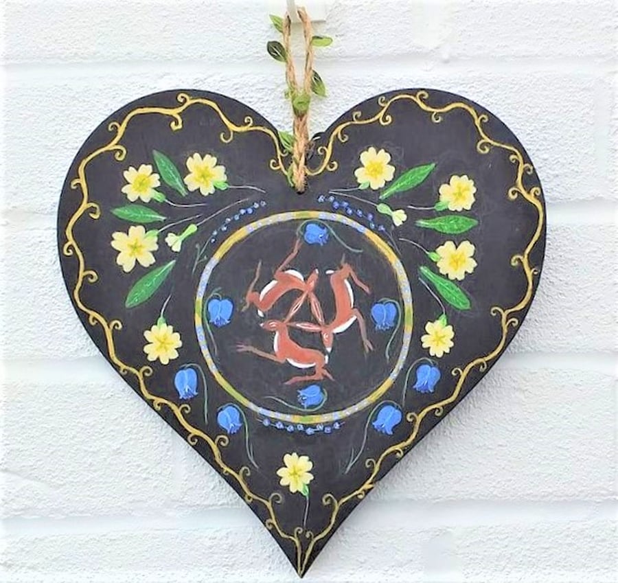 Hares and primroses on a wooden heart