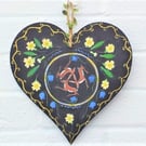 Hares and primroses on a wooden heart