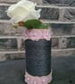 Dark grey yarn wrapped vase with pink flowers