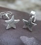 Tiny silver star stud earrings.