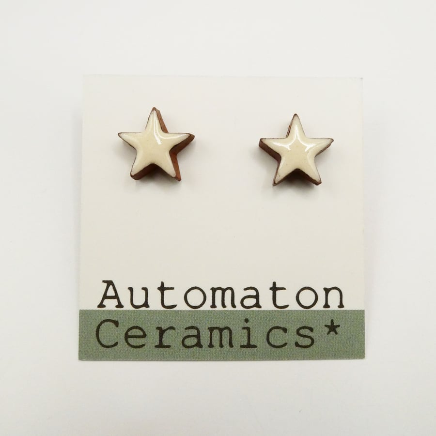 White stud earrings, star shaped studs