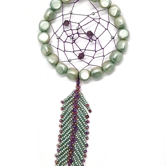 Small shimmering turquoise and purple beaded feather dream catcher