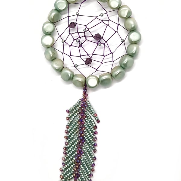 Small shimmering turquoise and purple beaded feather dream catcher