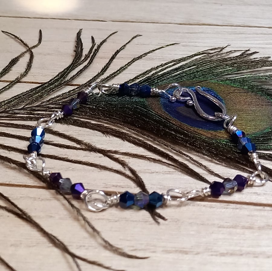 Twisted silver plated copper bracelet with glass beads