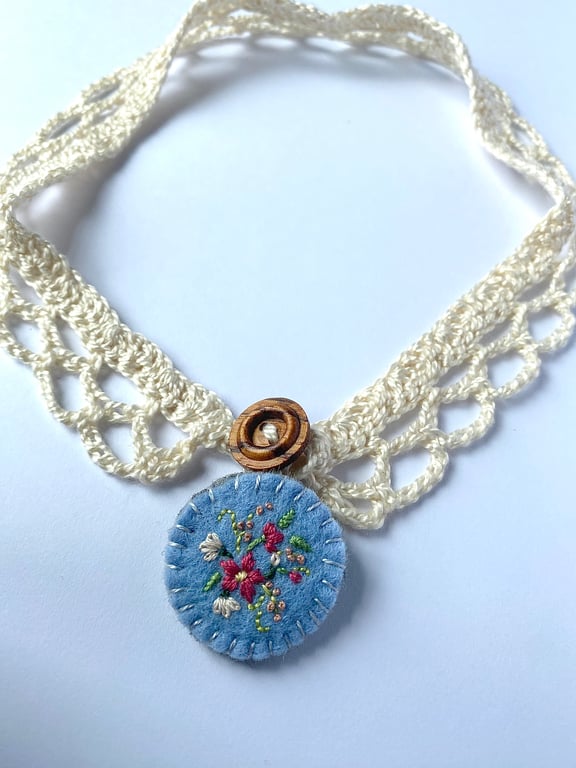 Crochet lace collar with blue embroidered wool felt pendant
