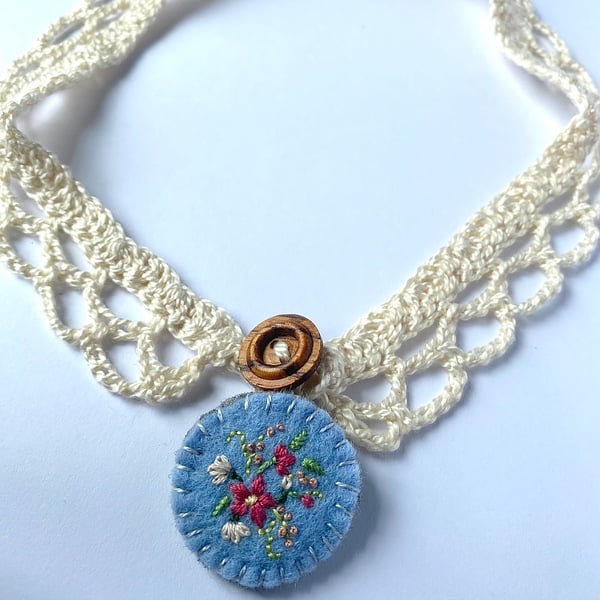 Crochet lace collar with blue embroidered wool felt pendant