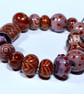 Handmade brown and purple lamp work glass beads