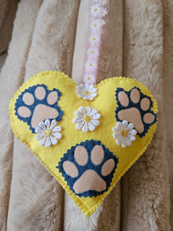 Hanging heart with pet paws and spring flowers