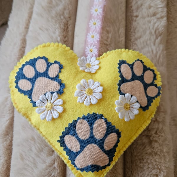 Hanging heart with pet paws and spring flowers