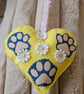 Hanging heart with pet paws and spring flowers