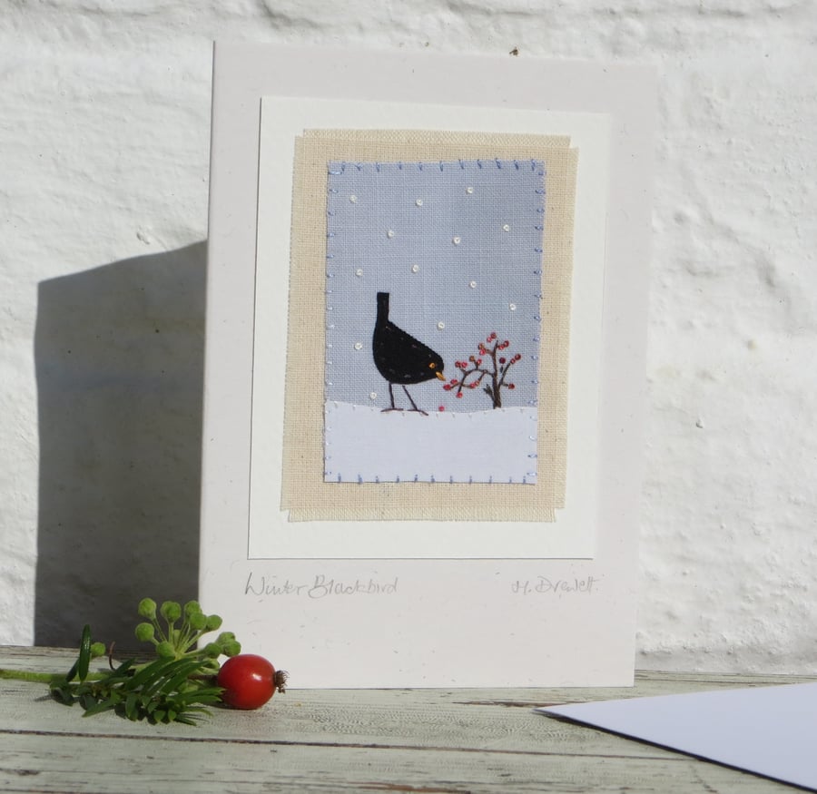 Winter Blackbird hand-stitched miniature on card with berries and falling snow