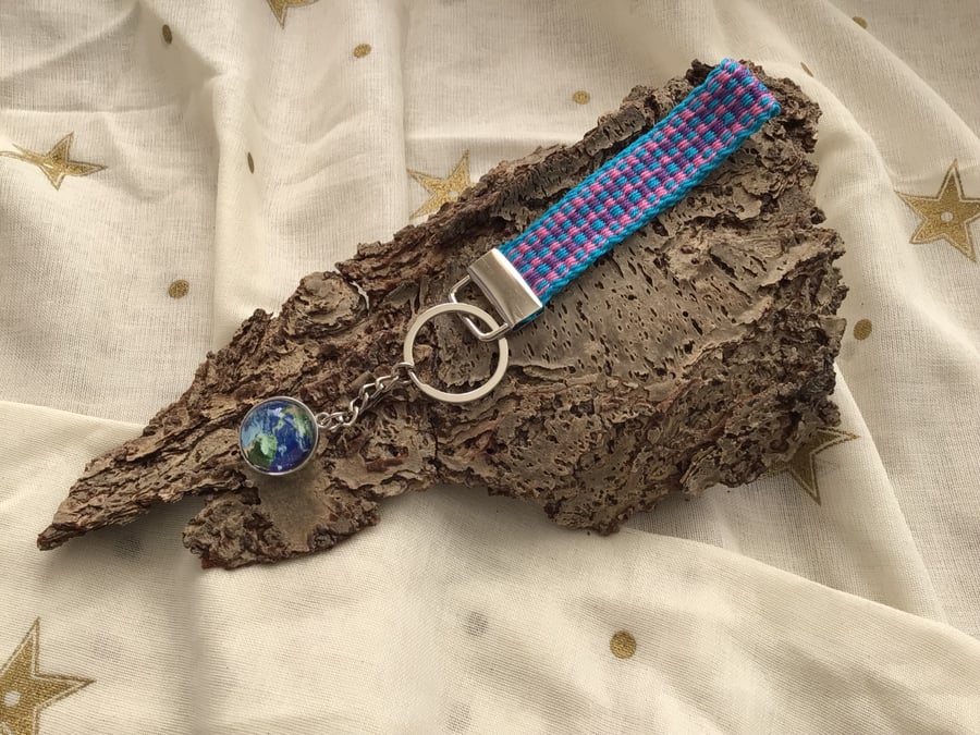 Hand woven key fob with attached Earth planet embellishment orb