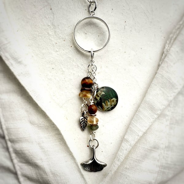 Silver Plated Charm Pendant Necklace featuring a fern charm. 