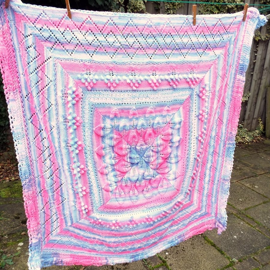 Hand knitted baby leaf shawl blanket in sparkly blue, pink and white