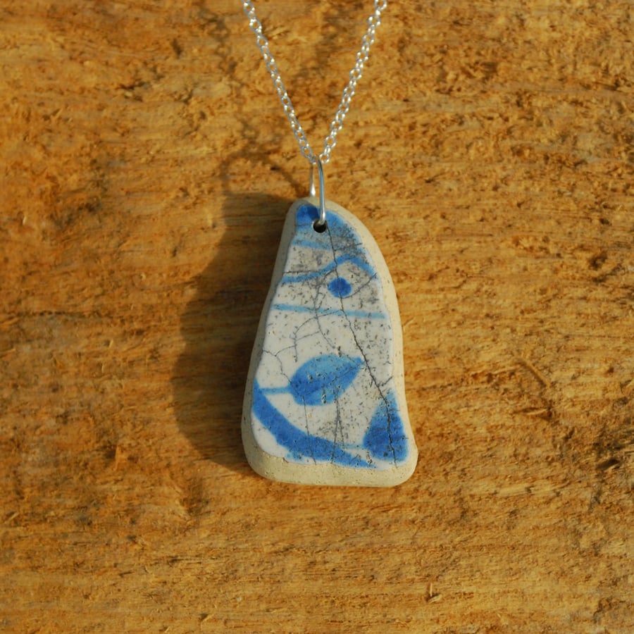 Beach pottery pendant with blue leaf