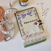 Sewing needle case in green fabric in a vintage style.