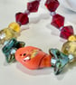 Slender glass bead bracelet in earthy shades of red and orange.  - Image 2